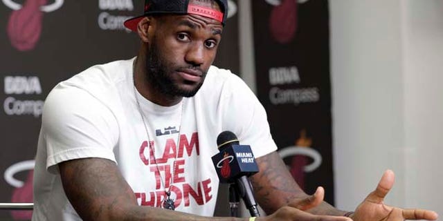 June 17, 2014: Miami Heat's LeBron James gestures as he answers a question during a news conference in Miami. (AP)