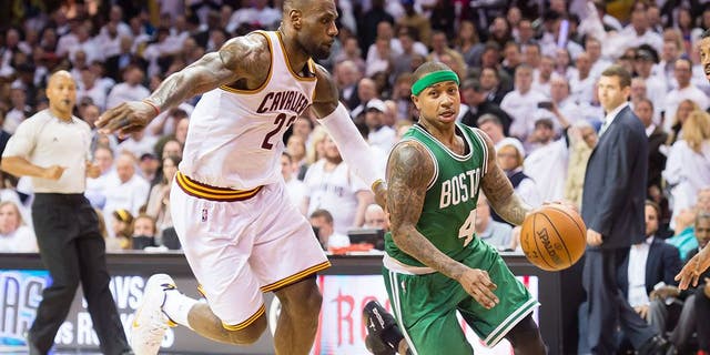 CLEVELAND, OH - APRIL 21: Isaiah Thomas #4 of the Boston Celtics drives around LeBron James #23 of the Cleveland Cavaliers in the second half in Game Two of the Eastern Conference Quarterfinals during the 2015 NBA Playoffs 2015 at Quicken Loans Arena on April 21, 2015 in Cleveland, Ohio. The Cavaliers defeated the Celtics 99-91. NOTE TO USER: User expressly acknowledges and agrees that, by downloading and or using this photograph, User is consenting to the terms and conditions of the Getty Images License Agreement. (Photo by Jason Miller/Getty Images)