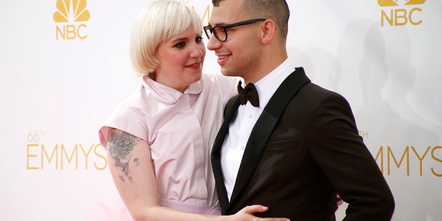 Actress Lena Dunham, left, said she was engaged after splitting with Jack Antonoff, right. Now she's 'totally single.'