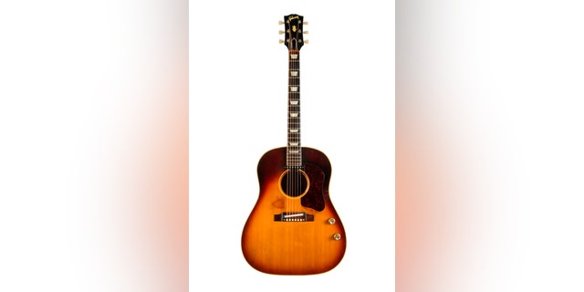The Gibson J-160E guitar (Julien's Auctions).