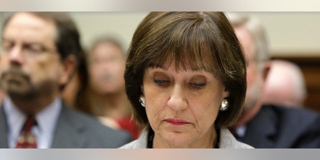 U.S. Director of Exempt Organizations for the Internal Revenue Service, Lois Lerner, takes her seat before a House Oversight and Government Reform Committee hearing on alleged targeting of political groups seeking tax-exempt status by the IRS, on Capitol Hill in Washington, May 22, 2013. REUTERS/Jonathan Ernst (UNITED STATES - Tags: POLITICS BUSINESS) - RTXZWJ3