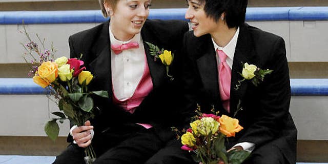 Desiree Shelton, left, and Sarah Lindstrom visit on the bleachers prior to the Royalty Court procession at the Snow Days Pep Fest at Champlin Park High School Monday, Jan. 31, 2011 in Champlin, Minn.