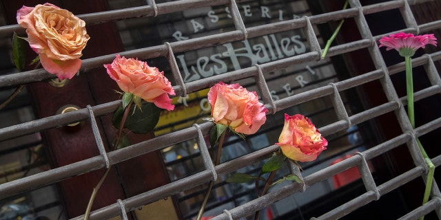 The building that once housed Les Halles is now being covered in flowers, trinkets and notes.