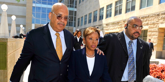 In this June 30, 2011 photo, Rev. Jonathan L. Weaver, left, walks with Prince Georges County Council member Leslie Johnson outside the U.S. District Court in Greenbelt, Md.