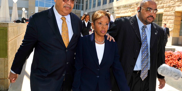 In this June 30, 2011 photo, Rev. Jonathan L. Weaver, left, walks with Prince Georges County Council member Leslie Johnson outside the U.S. District Court in Greenbelt, Md.