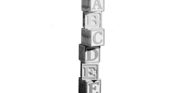 17th July 1962:  A wobbly tower of building blocks with the letters of the alphabet on them.  Marlon House.  (Photo by Chaloner Woods/Getty Images)