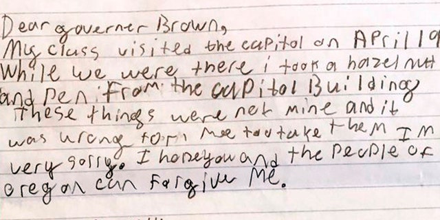 This photo provided by the Office of Oregon Gov. Kate Brown shows a portion of an apology letter from a fourth-grader to Gov. Brown, explaining that his class had toured the Capitol on a field trip in April 2017 and how he took a hazelnut and a pen from the Capitol Building.