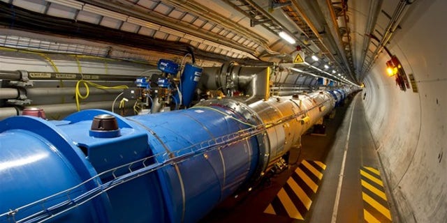 This photo shows the tunnel of the Large Hadron Collider, where beams of particles pass through the central pipes before colliding with each other.