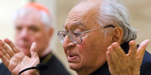 Feb. 25, 2014: Peruvian theologian Gustavo Gutierrez speaks during the presentation of the book, to which he contributed, "Poor for the poors, the mission of the Church" by Cardinal Gerhard Ludwig Mueller, background, in Vatican City.