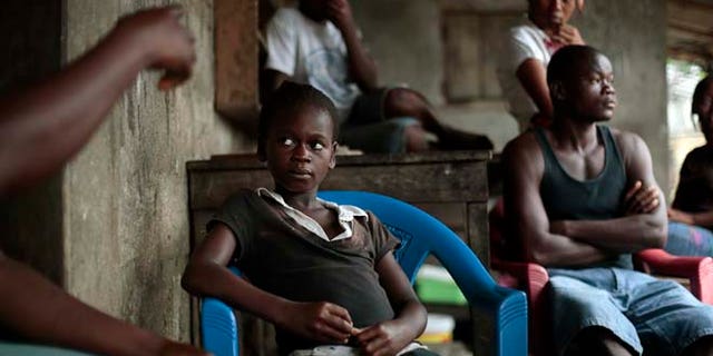 Sept. 28, 2014: Kumba "survivor" Fayiah, 11, sits with relatives in her  St Paul Bridge home in  Monrovia, Liberia. Fayah, who lost both parents and her sister, recovered from the Ebola virus and is now living with her extended family.