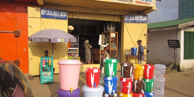 Aug. 4, 2014: According to local reports the sale of water buckets has increased dramatically, because they are used by Liberian people to fill with disinfectant and to wash their hands to prevent the spread of the deadly Ebola virus, in the city of Monrovia, Liberia. Dozens of local doctors and medical staff are among the dead, as foreign aid workers are arriving to help fight the Ebola outbreak and the Liberian government Information Minister Lewis Brown announced that all Ebola victims are to be cremated as fears rise that the disease could spread with bodies being buried in residential areas. (AP/Jonathan Paye-Layleh)