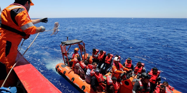 Migrants are rescued by "Save the Children" NGO crew from the ship Vos Hestia in the Mediterranean sea off Libya coast, June 15, 2017. REUTERS/Stefano Rellandini - RTS1792D