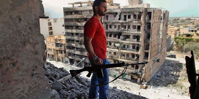 April 23: A Libyan rebel fighter looks out from a high building in the besieged city of Misrata, Libya. Government troops retreated to the outskirts of Misrata under rebel fire Saturday and the opposition claimed victory after officials in Tripoli decided to pull back forces loyal to Muammar al-Qaddafi following nearly two months of laying siege to the western city. (AP)