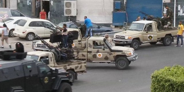 May 18, 2014: In this image made from video provided by the Libyan national army via AP Television, Tripoli joint security forces on vehicles with heavy artillery stand guard on the entrance road to the parliament area after troops of Gen. Khalifa Hifter targeted Islamist lawmakers and officials at the parliament in Tripoli, Libya.