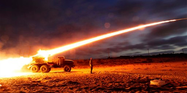 June 20: Rebel fighters fire a rocket at the front line west of Misrata, Libya.
