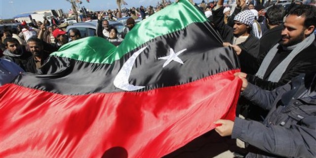 Libyan protesters wave the old Libyan flag in the Libyan city of Benghazi Feb. 28.