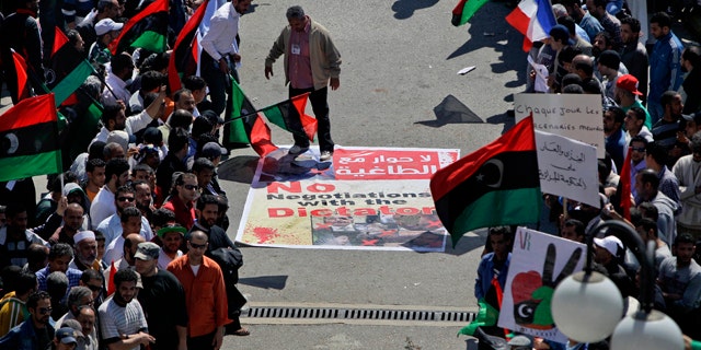 April 11: An angry but peaceful crowd lines the route to the Tibesty Hotel where an African Union delegation was meeting with opposition leaders in Benghazi, Libya. The African Union delegation took its cease-fire proposal to the rebels' eastern stronghold and was met with protests by crowds opposed to any peace until the country's longtime leader Muammar Qaddafi gives up power. (AP)