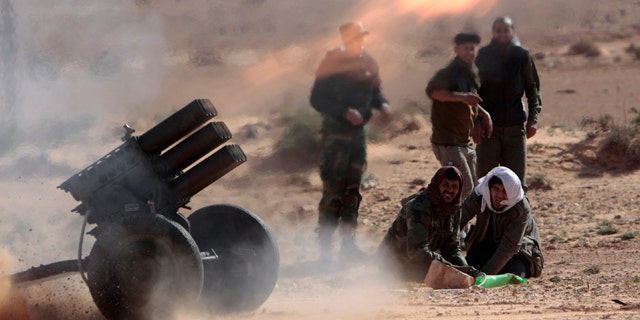 March 6, 2011: Anti-Libyan Leader Moammar Gadhafi rebels, fire multiple launcher rockets during a fighting against pro-Gadhafi fighters near the town of Bin-Jawad, eastern Libya. Thousands of Moammar Gadhafi's supporters poured into the streets of Tripoli on Sunday, waving flags and firing their guns into the air in the Libyan leader's main stronghold.