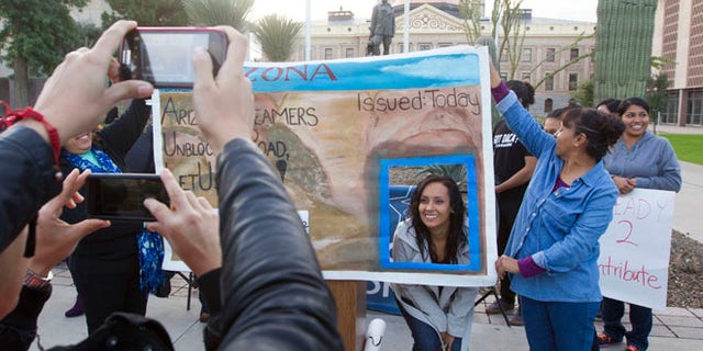 Dec. 17, 2014: Erika Andiola gets her portrait taken at the Arizona State Capitol on Dec 17, 2014, in Phoenix, Ariz. (AP)
