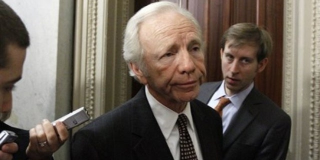 Sen. Joe Lieberman pauses before heading into a Democratic caucus on health care reform in Washington, in this Nov. 18, 2009, file photo. (AP Photo)
