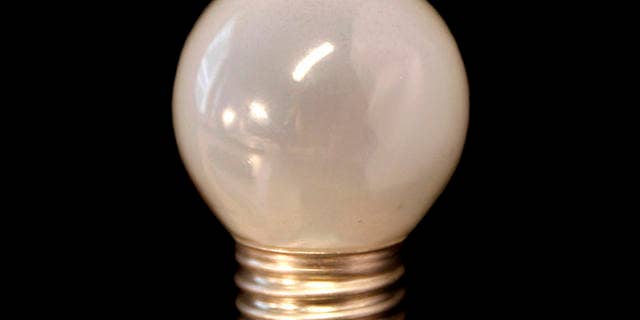 An older style frosted 60 watt incandescent bulb is seen in Brussels, Tuesday Sept. 1, 2009. The EU on Tuesday began making the transition from power-draining lightbulbs to more energy efficient ones. The new EU rules follow an agreement reached by the 27 EU governments last year to phase out the traditional incandescent lightbulb over three years starting this year to help European countries lower greenhouse gas emissions. The older lightbulbs will be replaced by halogen or long-life fluorescent bulbs. (AP Photo/Virginia Mayo)