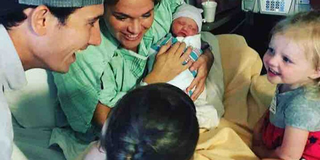 Crosby is pictured with her husband, Evan, and their three children shortly after giving birth to their youngest.