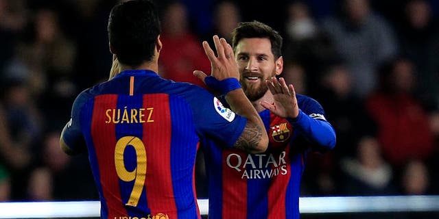 FC Barcelona's Lionel Messi, right, celebrates after scoring with his teammate Luis Suarez during the Spanish La Liga soccer match between Villarreal and Barcelona at the Ceramica stadium in Villarreal, Spain, Sunday, Jan. 8, 2017. (AP Photo/Alberto Saiz)