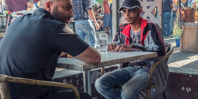 Lior Raz (left) in a scene from the first episode of Season 2 of "Fauda."
