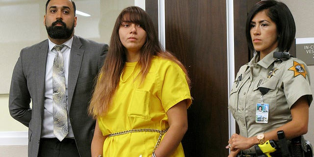 FILE - In this July 28, 2017 file photo, Obdulia Sanchez, 18, middle, appears in a Los Banos, Calif., branch of the Merced County Superior Court with her public defender, Ramnik Samrao. In a court appearance Friday, Aug. 11, 2017, her attorney said Sanchez, accused of driving drunk while livestreaming the July 21, 2017 crash that killed her younger sister, said a mechanical problem may have caused the accident. (AP Photo/Scott Smith, File)