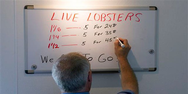 June 28, 2012: Bob Coppersmith updates the price board at Dock's Seafood Restaurant in South Portland, Maine. Many stores are selling the king of seafood for under $5 a pound, making it cheaper than bologna by weight.