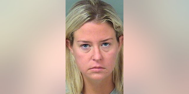 This photo provided provided by the Palm Beach County Sheriff's Office shows Kate Major Lohan shortly after her arrest on a battery charge in Boca Raton, Fla., on Friday, July 27, 2018. Kate Lohan, 35, is the stepmother of actress Lindsay Lohan. (Palm Beach County Sheriff's Office via AP)