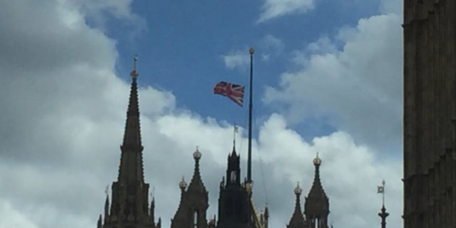 The British flag waves atop of a cathedral in London.