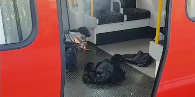 This is an image made from video showing burning items in underground train at the scene of an explosion in London Friday, Sept. 15, 2017. A reported explosion at a train station sent commuters stampeding in panic, injuring several people at the height of London's morning rush hour, and police said they were investigating it as a terrorist attack. (Sylvain Pennec via AP)