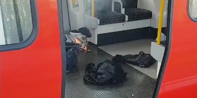This is an image made from video showing burning items in underground train at the scene of an explosion in London Friday, Sept. 15, 2017. A reported explosion at a train station sent commuters stampeding in panic, injuring several people at the height of London's morning rush hour, and police said they were investigating it as a terrorist attack. (Sylvain Pennec via AP)