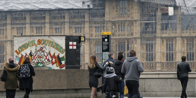 Pedestrians walk on Westminster bridge in London after it is reopened.