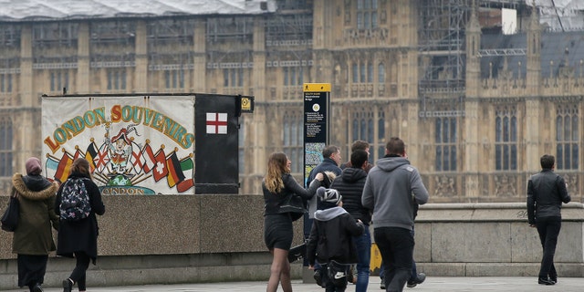 Pedestrians walk on Westminster bridge in London after it is reopened.