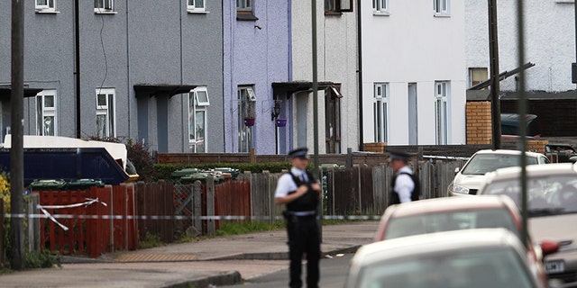 Police officers stand behind cordon tape near a property that was searched after an explosion on a London Underground train, in Sunbury-on-Thames, Britain, September 16, 2017. REUTERS/Peter Nicholls - RC198DFC0FE0