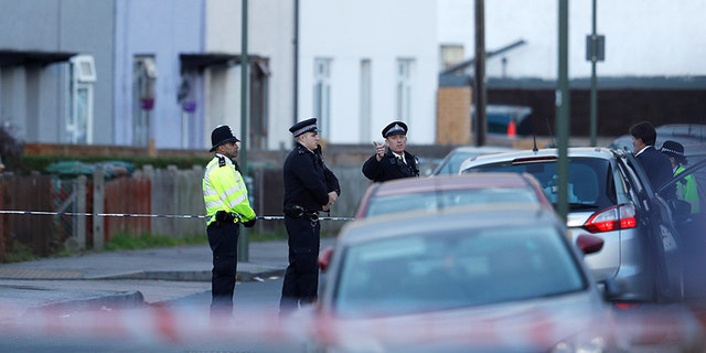 Police officers stand behind cordon tape near a property that was searched after a man was arrested in connection with an explosion on a London Underground train, in Sunbury-on-Thames, Britain, September 16, 2017. REUTERS/Peter Nicholls - RC1D0656CBA0