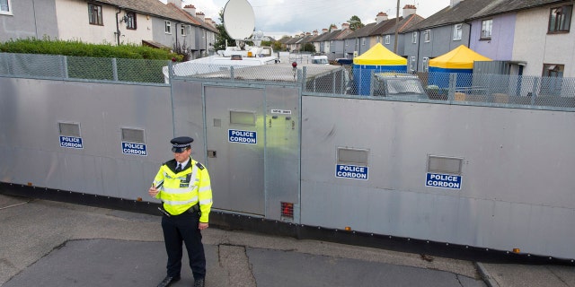 A police officer stands by a cordon on Cavendish Road, in Sunbury-on-Thames, in England, Monday, Sept. 18, 2017.