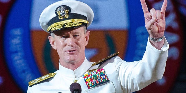 FILE - In this May 17, 2014 file photo Naval Adm. William H. McRaven, an alumnus, does the Longhorns' Hook 'em Horns hand signal during his commencement keynote address at the University of Texas in Austin. The University of Texas System regents on Tuesday, July 29, 2014, selected McRaven as the lone finalist for the job of chancellor, overseeing the systems 15 campuses and $14 billion budget. (AP Photo/ The University of Texas at Austin, Marsha Miller, File)