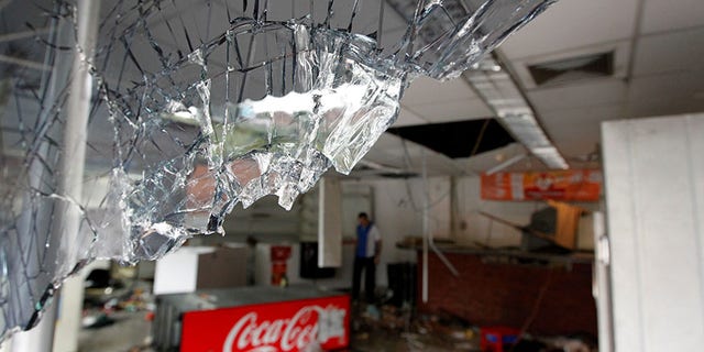 Broken glass is seen in a convenience store, after it was looted in Caracas, Venezuela April 21, 2017. REUTERS/Christian Veron - RTS13CRS