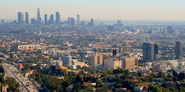 The skyline of Los Angeles with a layer of smog hanging over the city.