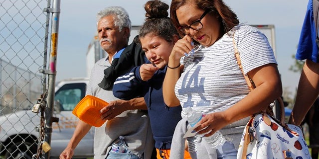 People pick up students following a shooting at the Salvador B. Castro Middle School in Los Angeles.