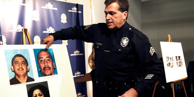 Feb. 6, 2017: Los Angeles police Sgt. Jack Richter displays photos of arson suspects from a 1993 fire prior to a news conference in Los Angeles