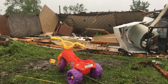 In Breaux Bridge, an EF-1 tornado flipped a trailer upside down, killing a sleeping mother and her 3-year-old daughter. A tricycle with yellow handles and purple wheels sits outside the wreckage Monday morning.