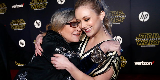 Actresses Carrie Fisher (L) and Billie Lourd embrace as they arrive at the premiere of "Star Wars: The Force Awakens" in Hollywood, California December 14, 2015. REUTERS/Mario Anzuoni - RTX1YP7W