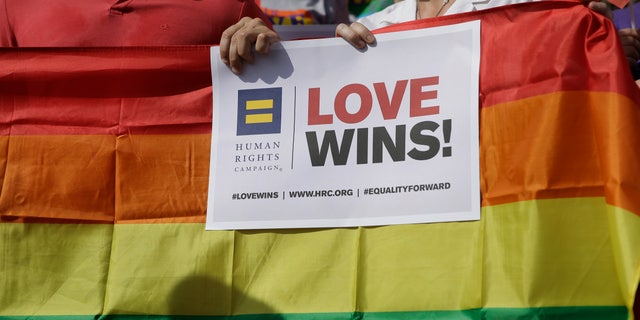 FILE - In this June 29, 2015, file photo, Supporters of the U.S. Supreme Courts ruling on same-sex marriage gather on the step of the Texas Capitol for a news conference celebrating marriage equality and looking to important work ahead in Austin, Texas.  (AP Photo/Eric Gay, File)