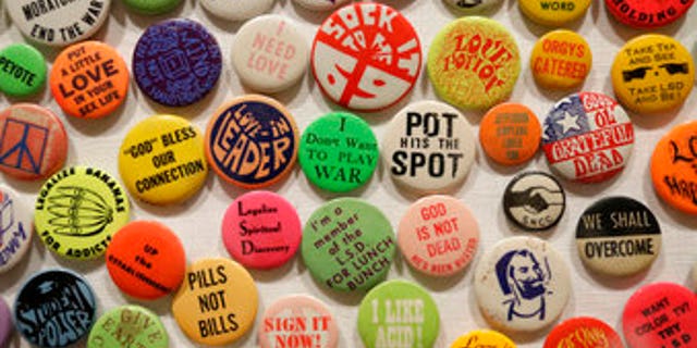 This Wednesday, May 10, 2017 photo shows a display of buttons in the exhibit "The Summer of Love Experience, Art, Fashion and Rock and Roll" in Golden Gate Park at the deYoung Museum in San Francisco. (AP Photo/Eric Risberg)
