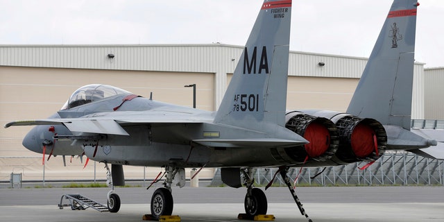 In this Aug. 27, 2014, file photo, a Massachusetts Air National Guard F-15C fighter aircraft sits near a hangar at Barnes Air National Guard Base, in Westfield, Mass