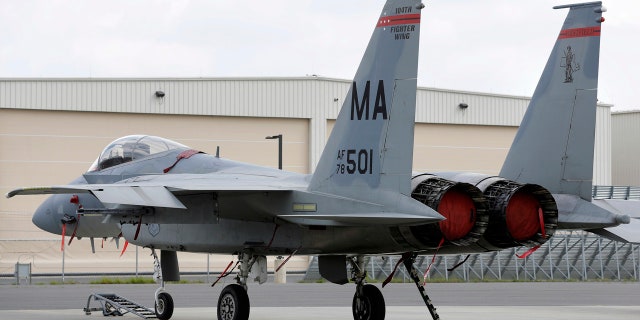 In this Aug. 27, 2014, file photo, a Massachusetts Air National Guard F-15C fighter aircraft sits near a hangar at Barnes Air National Guard Base, in Westfield, Mass